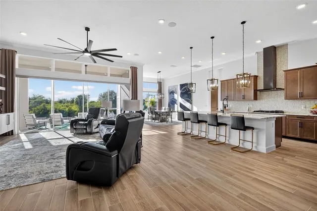 a kitchen with stainless steel appliances kitchen island granite countertop a stove a sink and a refrigerator