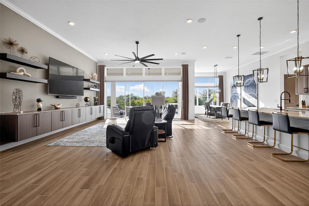 1088 Signet Drive Apollo Beach, FL 33572 - Photo 9 of 49 a living room with furniture wooden floor and a kitchen view