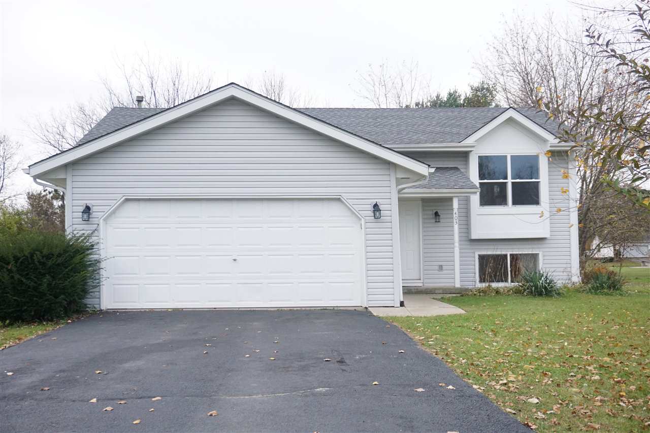 403 Pembroke Road Southwest Poplar Grove, IL 61065 - Photo 1 of 19 a front view of a house with a yard and garage