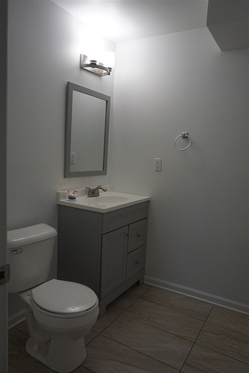 403 Pembroke Road Southwest Poplar Grove, IL 61065 - Photo 16 of 19 a bathroom with a toilet sink vanity and mirror
