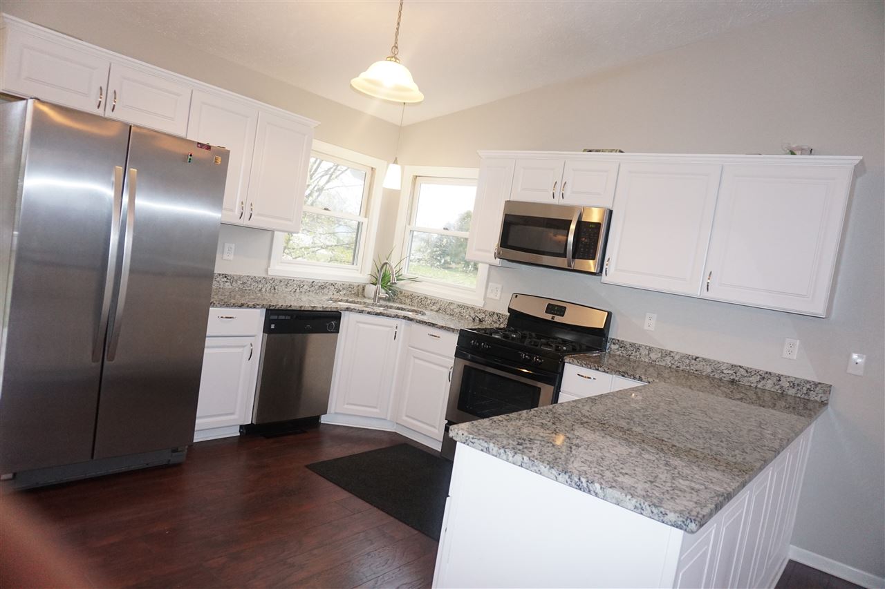 403 Pembroke Road Southwest Poplar Grove, IL 61065 - Photo 5 of 19 a kitchen with stainless steel appliances granite countertop a sink stove microwave and refrigerator