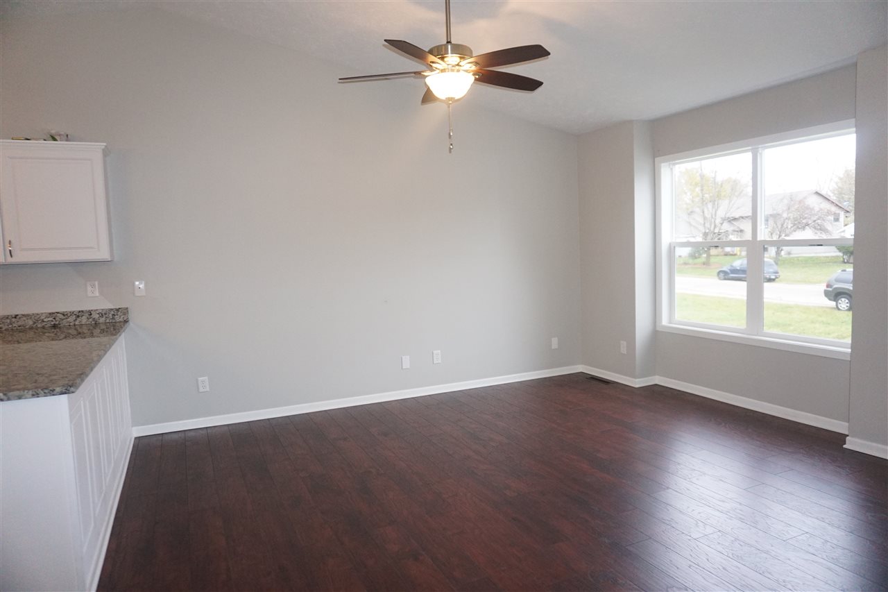 403 Pembroke Road Southwest Poplar Grove, IL 61065 - Photo 7 of 19 wooden floor in an empty room with a window