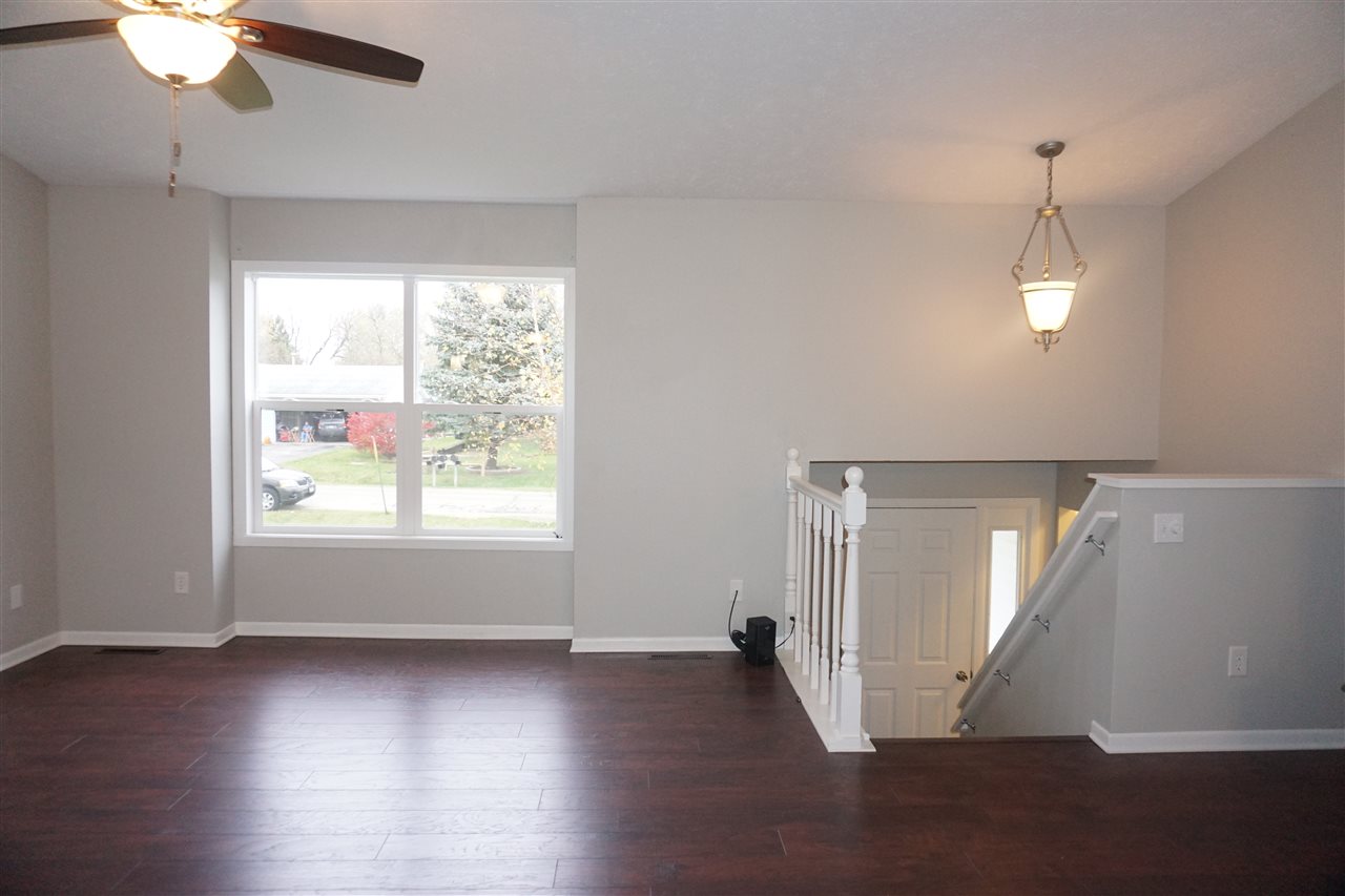 403 Pembroke Road Southwest Poplar Grove, IL 61065 - Photo 8 of 19 a view of an empty room with wooden floor and a window