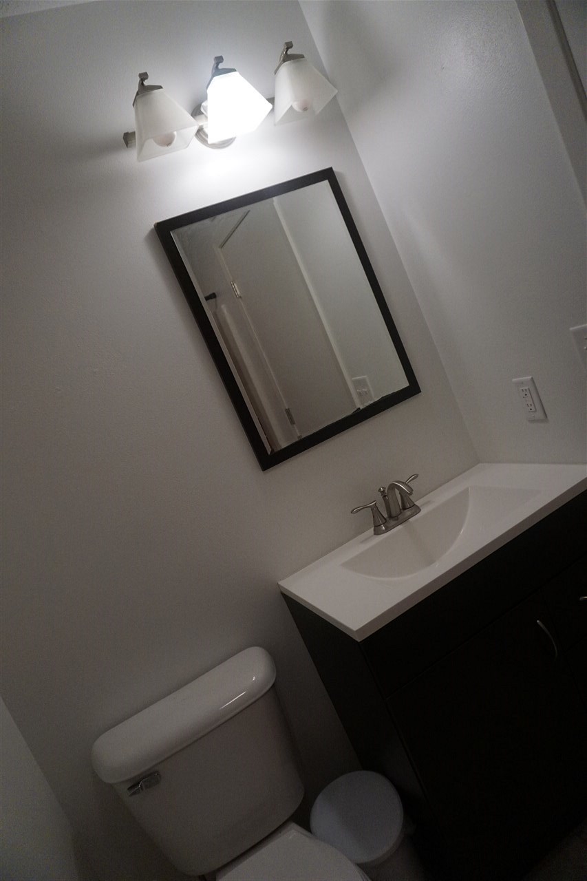 403 Pembroke Road Southwest Poplar Grove, IL 61065 - Photo 10 of 19 a bathroom with a toilet sink and mirror