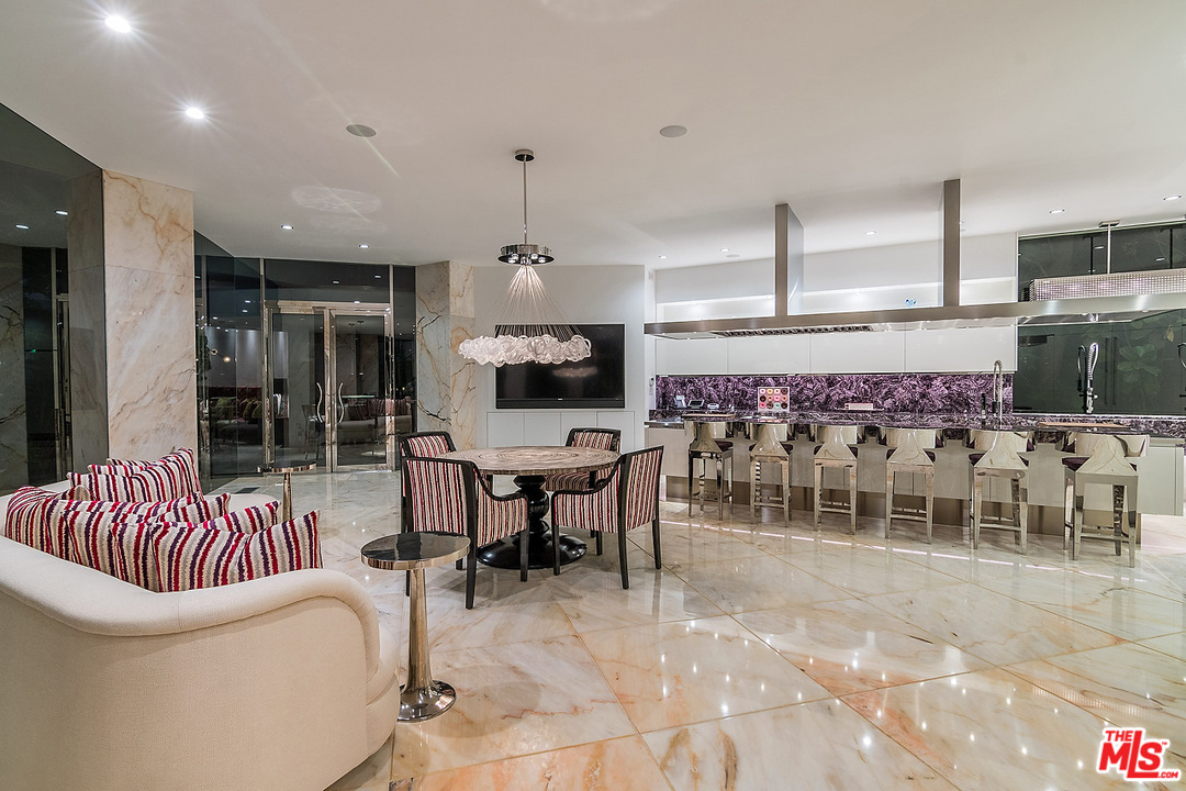 1000 Elden Way Beverly Hills, CA 90210 - Photo 14 of 53 a living room with furniture a flat screen tv and a floor to ceiling window