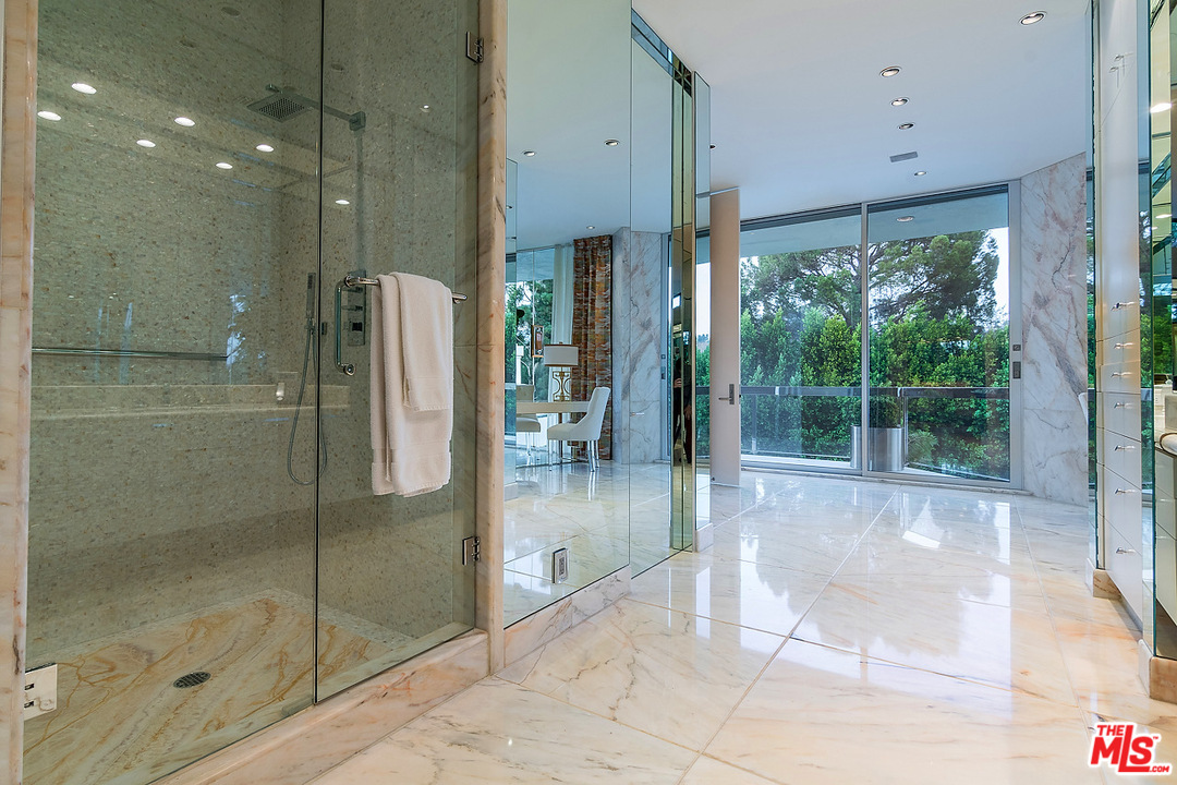 1000 Elden Way Beverly Hills, CA 90210 - Photo 22 of 53 a bathroom with a glass shower door