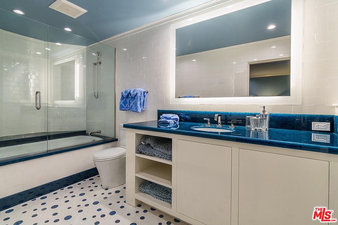 1000 Elden Way Beverly Hills, CA 90210 - Photo 31 of 53 a bathroom with a sink a toilet and a mirror