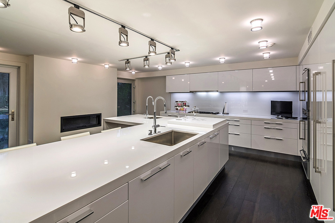 1000 Elden Way Beverly Hills, CA 90210 - Photo 41 of 53 a large kitchen with a large counter top appliances and cabinets