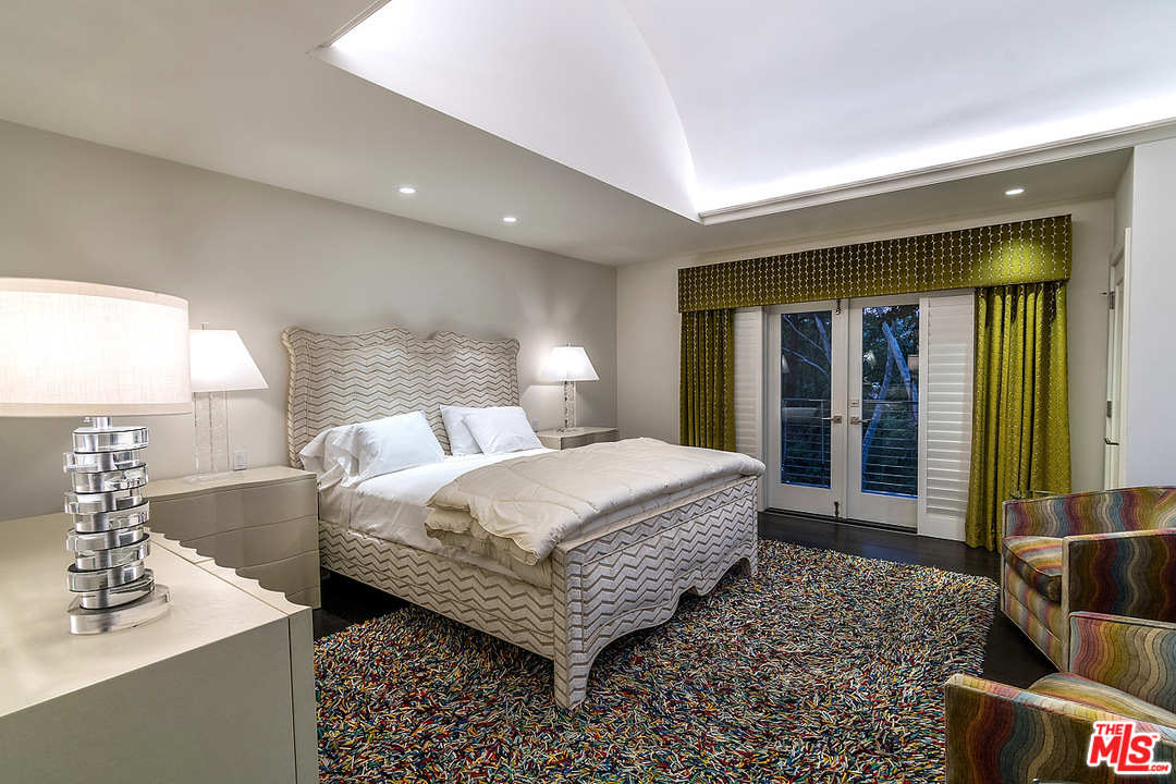 1000 Elden Way Beverly Hills, CA 90210 - Photo 47 of 53 a bedroom with a bed and a mirror