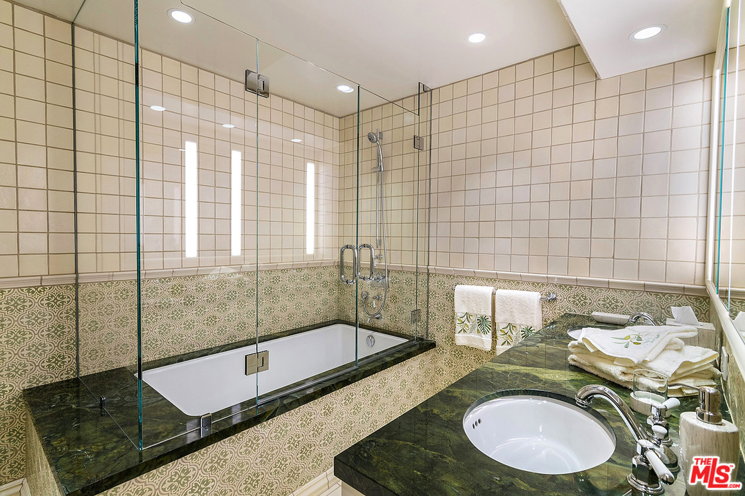 1000 Elden Way Beverly Hills, CA 90210 - Photo 48 of 53 a bathroom with a granite countertop sink and a mirror