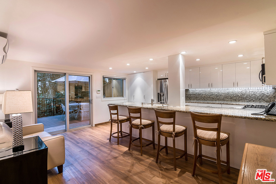 1000 Elden Way Beverly Hills, CA 90210 - Photo 52 of 53 a dining hall with stainless steel appliances granite countertop a dining table and chairs