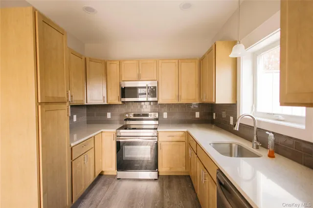 a view of a kitchen with a stove cabinets and wooden floor