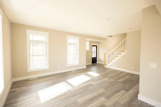 a kitchen with stainless steel appliances a sink a stove a microwave a sink a refrigerator and cabinets