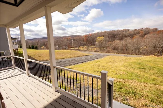 a view of a balcony with wooden floor