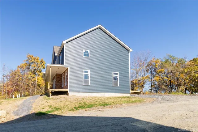 a view of a house with snow on the road
