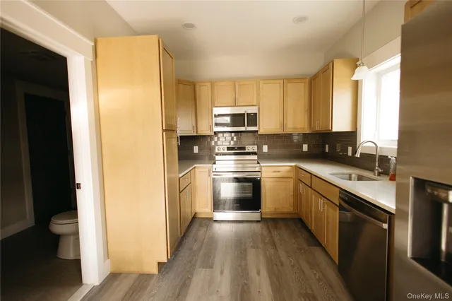 a kitchen with a sink stove and refrigerator