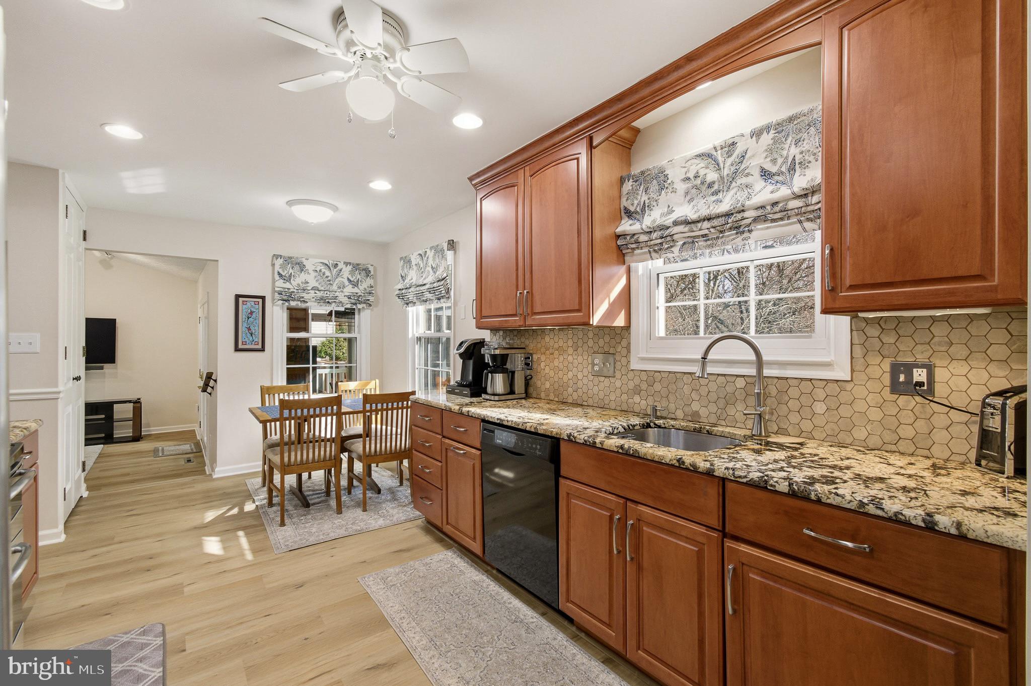 4705 Ilkley Moor Lane Ellicott City, MD 21043 - Photo 11 of 69 a kitchen with stainless steel appliances granite countertop sink stove refrigerator and cabinets