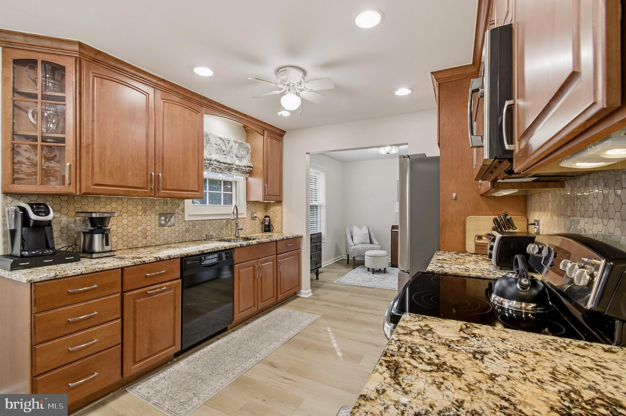 4705 Ilkley Moor Lane Ellicott City, MD 21043 - Photo 13 of 69 a large kitchen with stainless steel appliances granite countertop a sink dishwasher stove and refrigerator