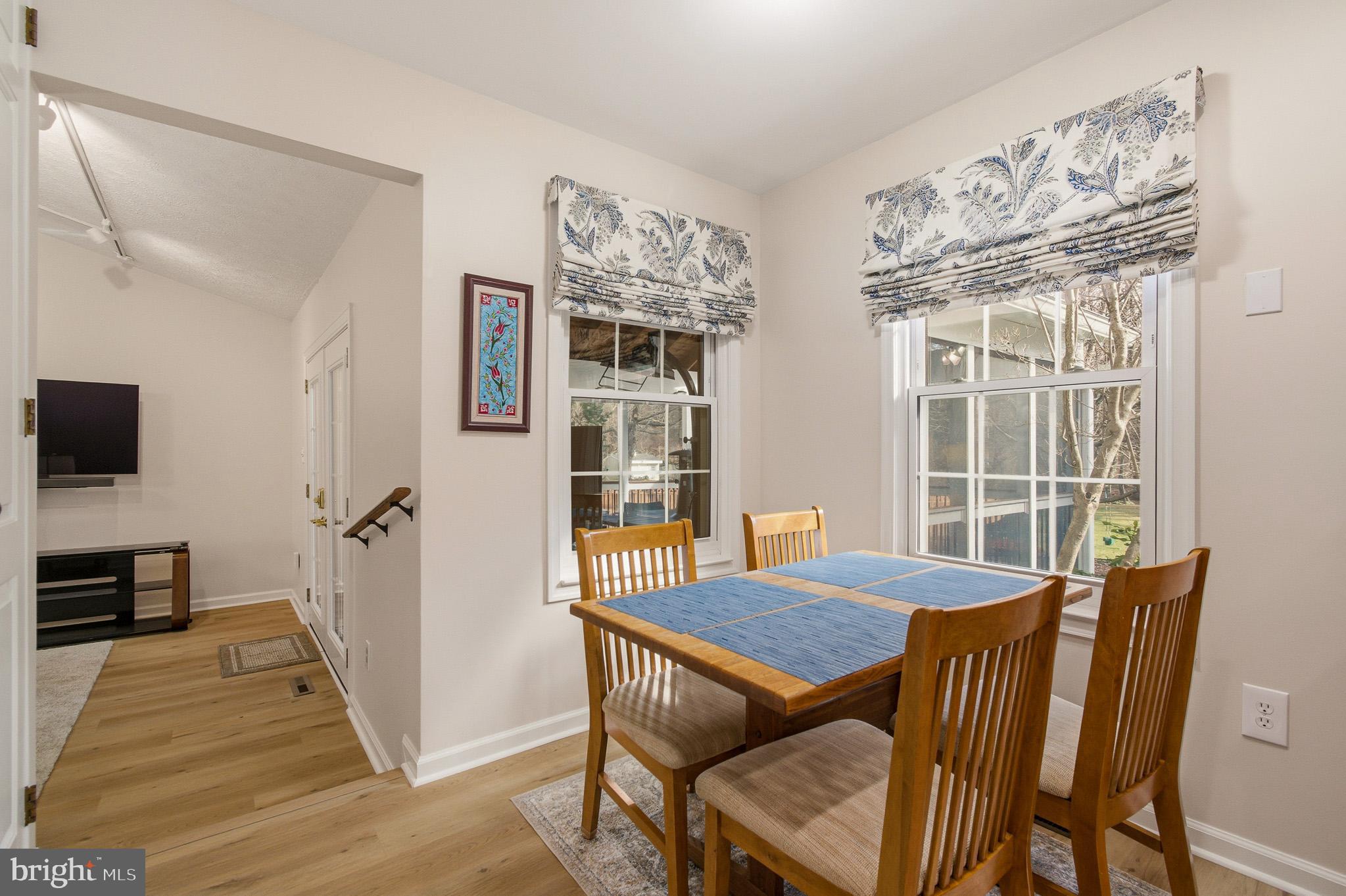 4705 Ilkley Moor Lane Ellicott City, MD 21043 - Photo 16 of 69 a view of a dining room with furniture window and wooden floor