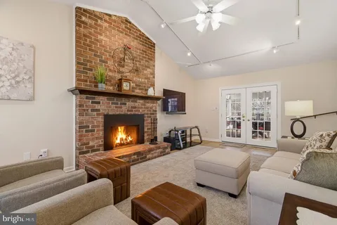 a spacious bedroom with a bed and a chandelier