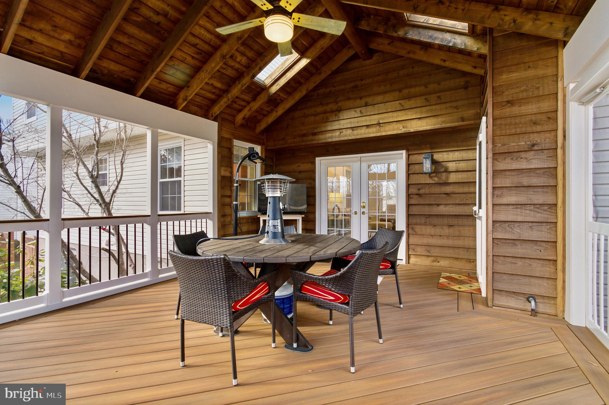 4705 Ilkley Moor Lane Ellicott City, MD 21043 - Photo 27 of 69 a view of a deck with table and chairs with wooden floor and fence