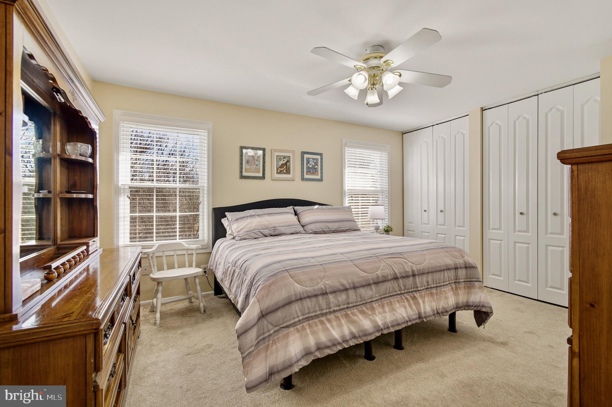 4705 Ilkley Moor Lane Ellicott City, MD 21043 - Photo 30 of 69 a spacious bedroom with a bed and a chandelier