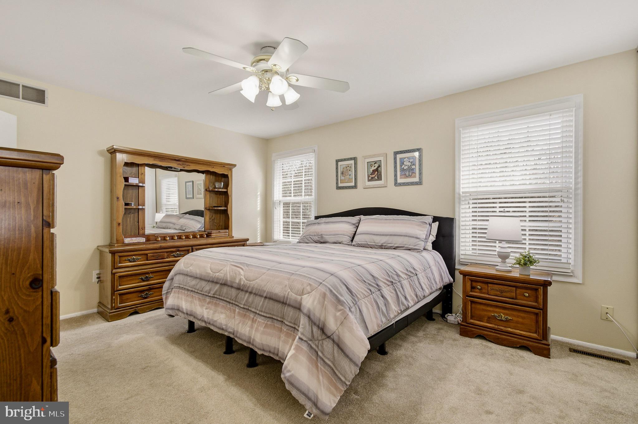 4705 Ilkley Moor Lane Ellicott City, MD 21043 - Photo 31 of 69 a spacious bedroom with a bed and a chandelier