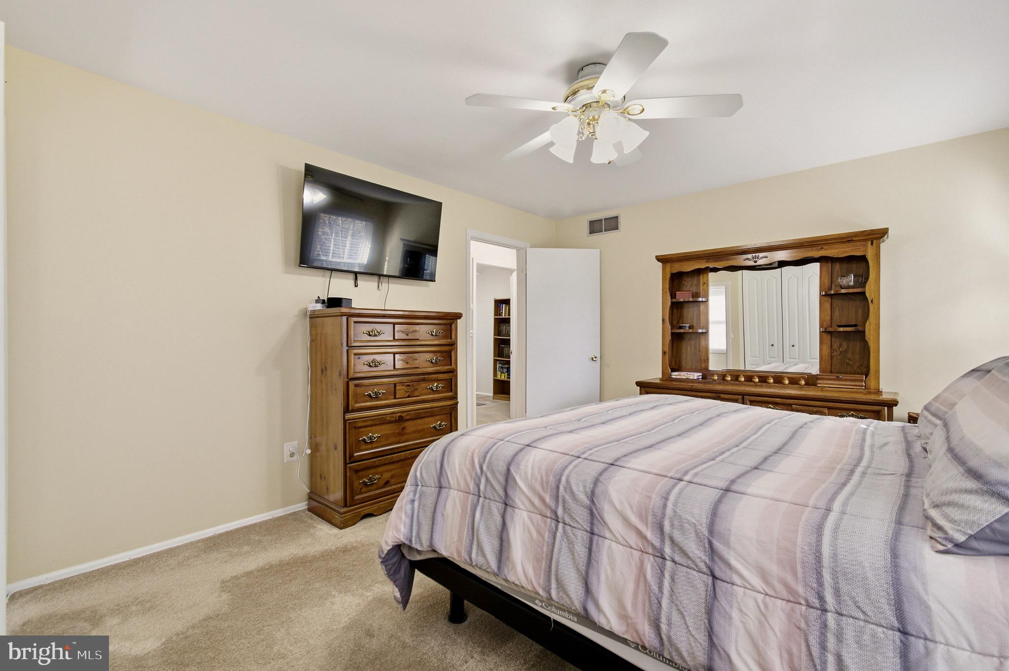 4705 Ilkley Moor Lane Ellicott City, MD 21043 - Photo 32 of 69 a bedroom with a bed and a flat screen tv