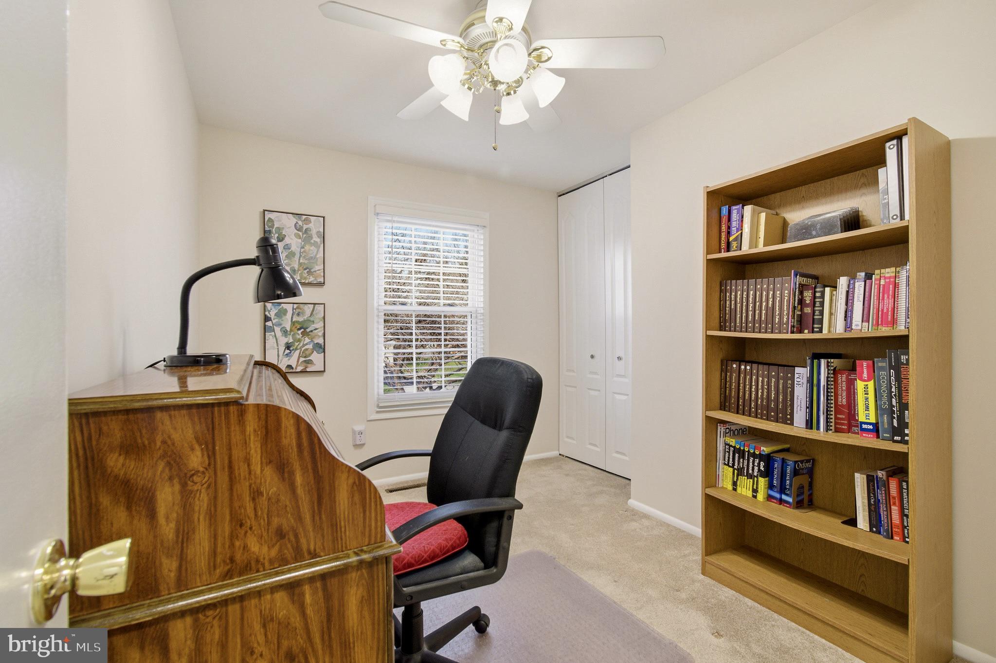 4705 Ilkley Moor Lane Ellicott City, MD 21043 - Photo 39 of 69 a view of a workspace with furniture and a book shelf