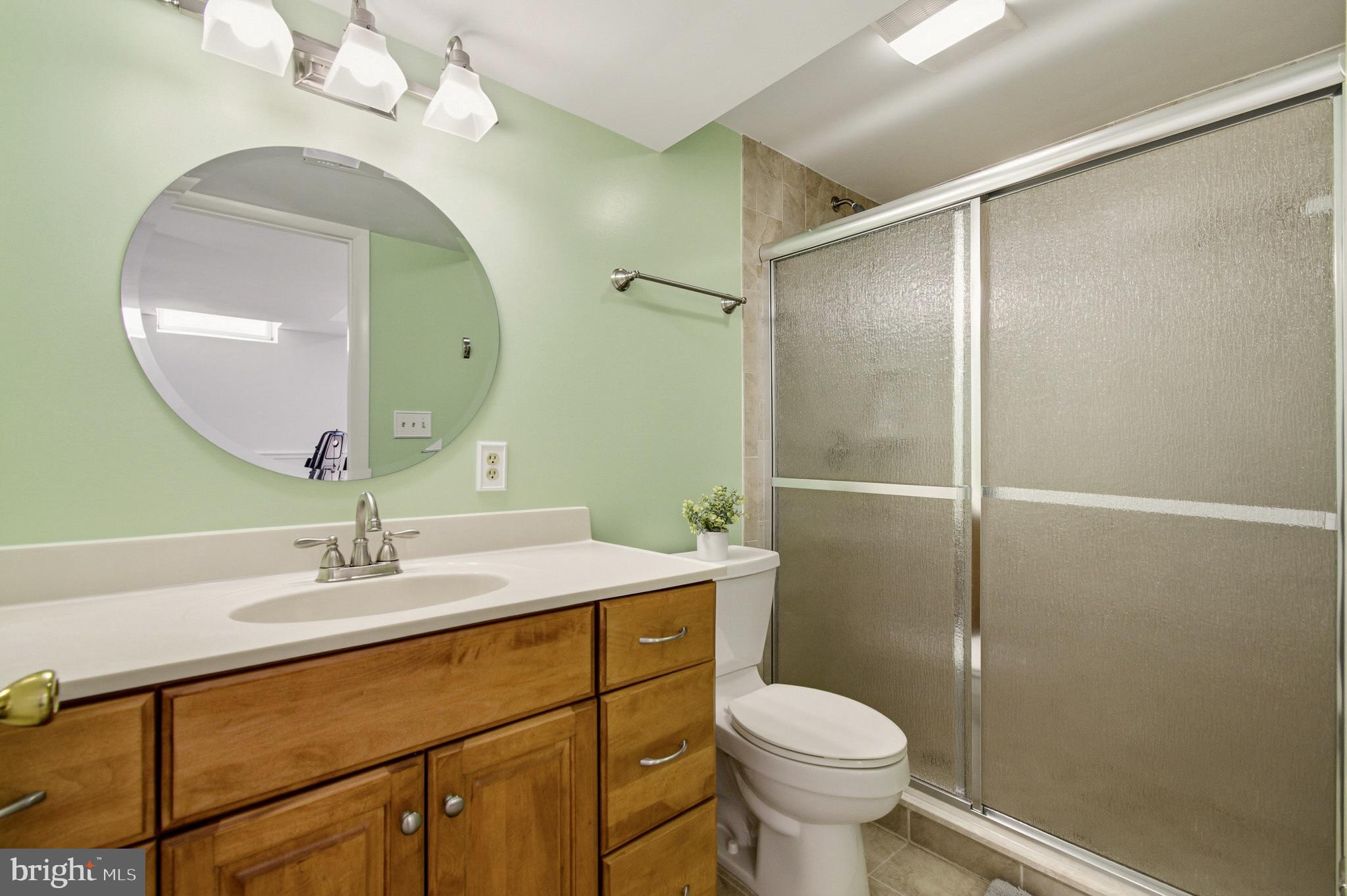 4705 Ilkley Moor Lane Ellicott City, MD 21043 - Photo 47 of 69 a bathroom with a sink toilet and shower
