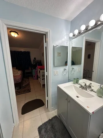 a bathroom with a sink a mirror and a shower