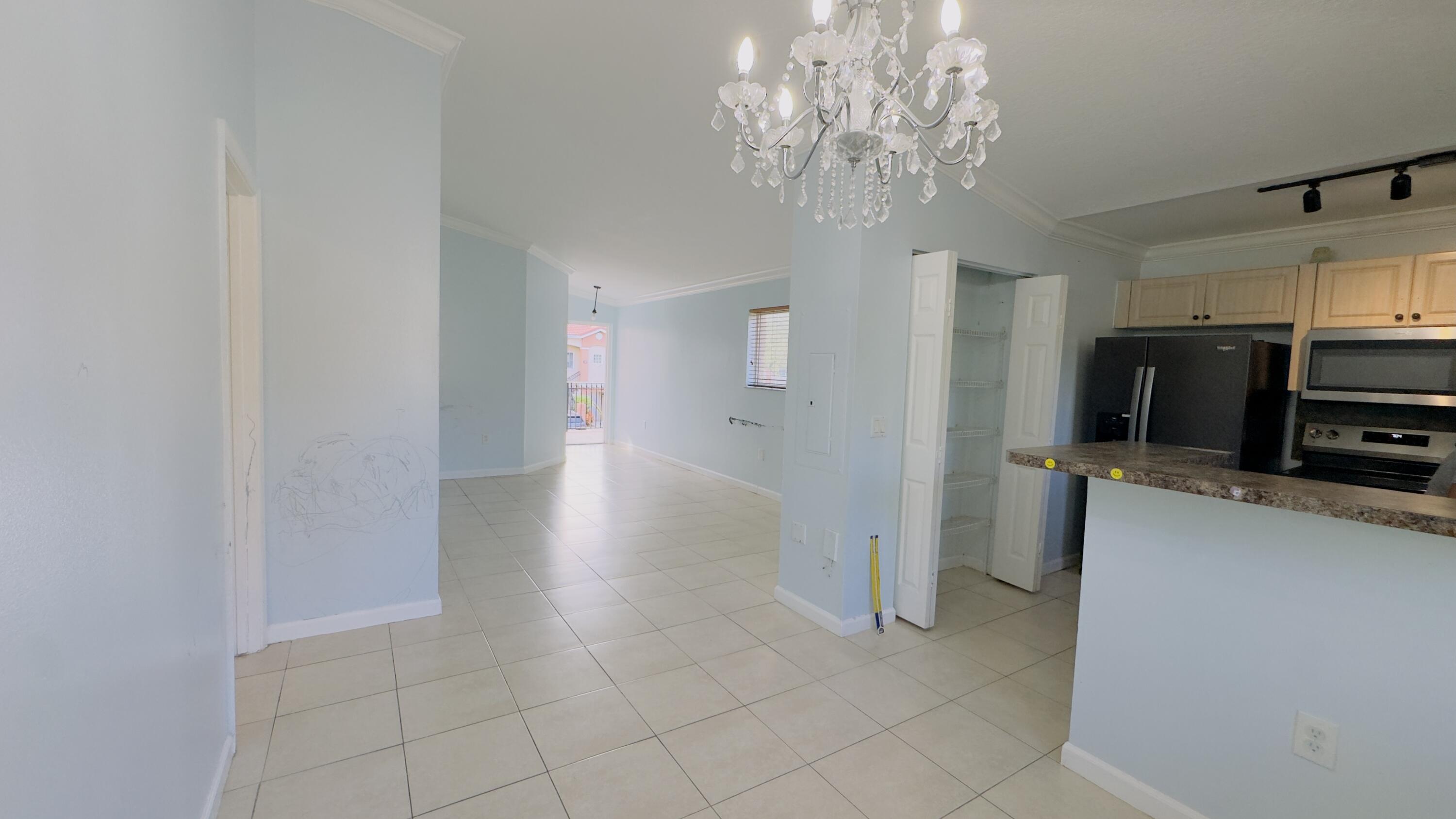 3481 Briar Bay Boulevard, Unit 201 West Palm Beach, FL 33411 - Photo 13 of 19 a view of a kitchen with electric appliances