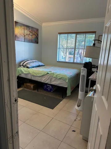 a bedroom with a bed and dresser