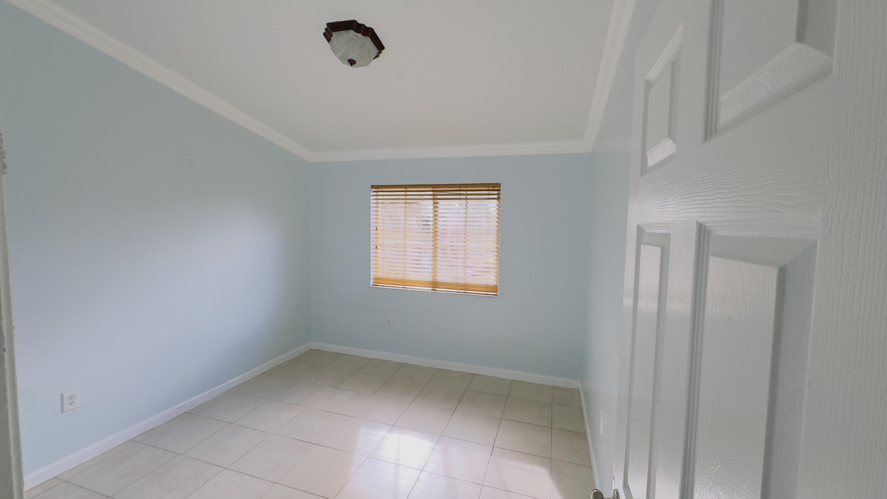 3481 Briar Bay Boulevard, Unit 201 West Palm Beach, FL 33411 - Photo 17 of 19 a view of a room that has a window in it
