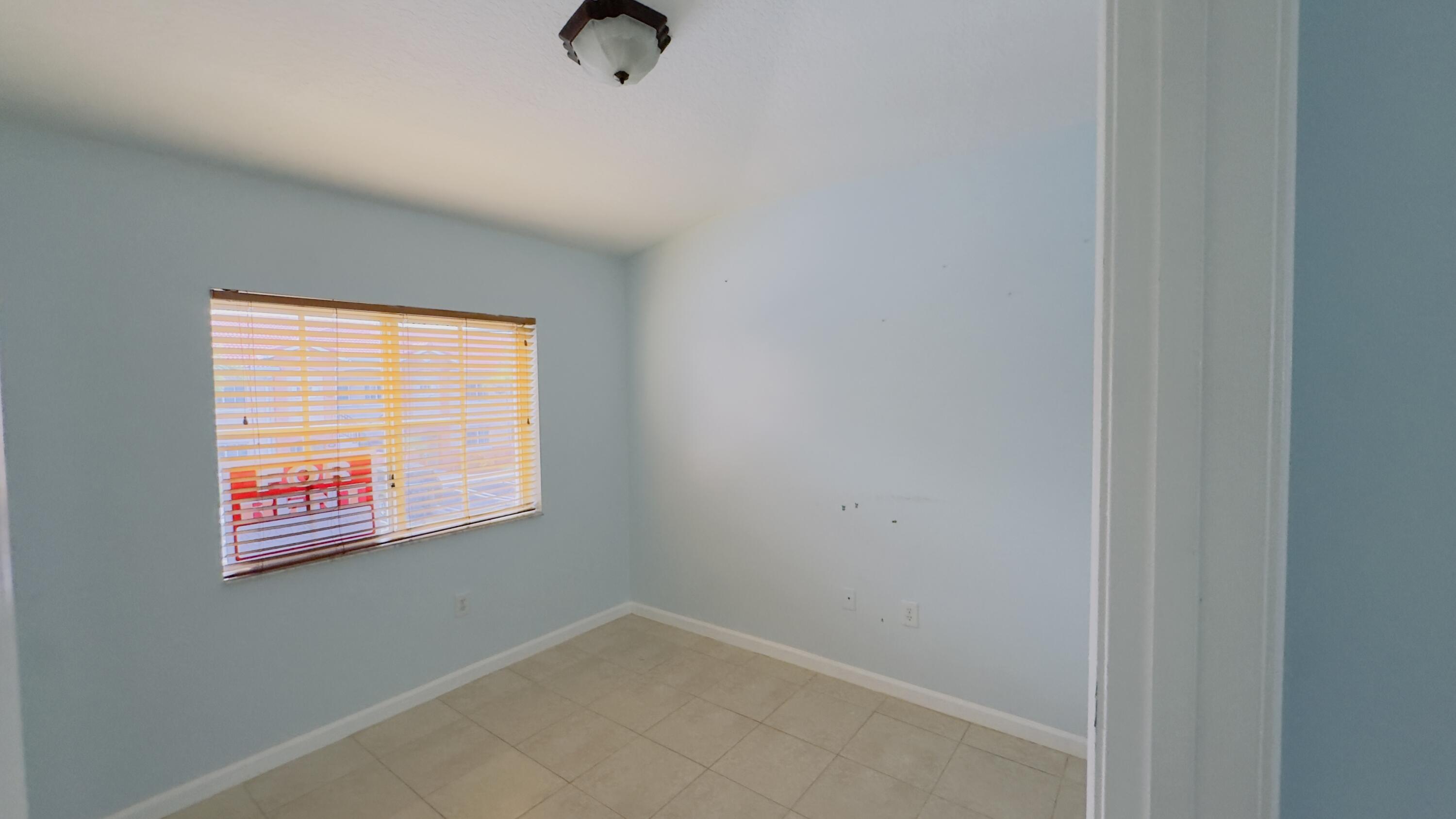 3481 Briar Bay Boulevard, Unit 201 West Palm Beach, FL 33411 - Photo 18 of 19 an empty room with windows