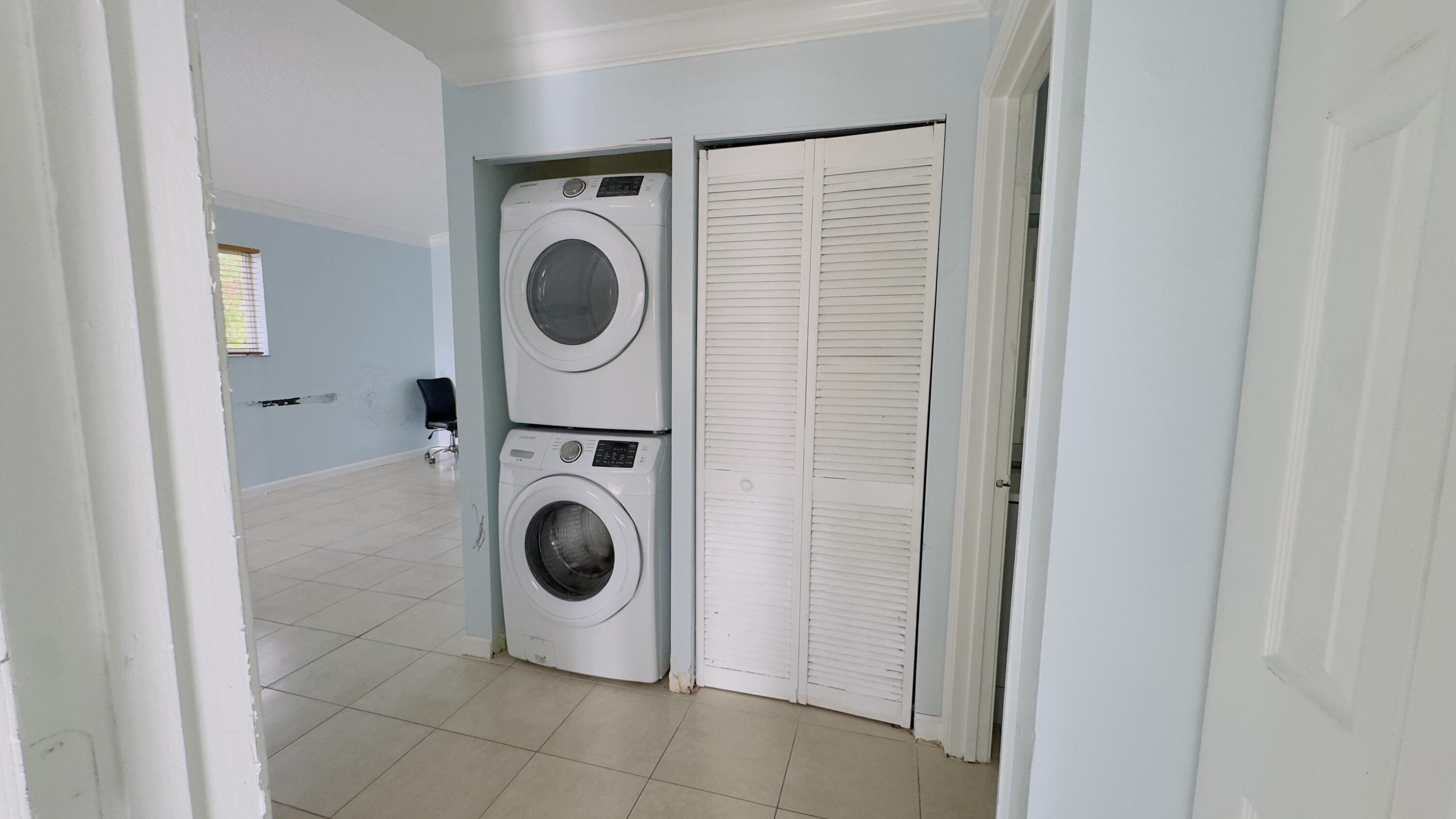 3481 Briar Bay Boulevard, Unit 201 West Palm Beach, FL 33411 - Photo 6 of 19 a utility room with dryer and washer
