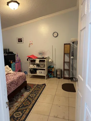 a bedroom with furniture and a rug