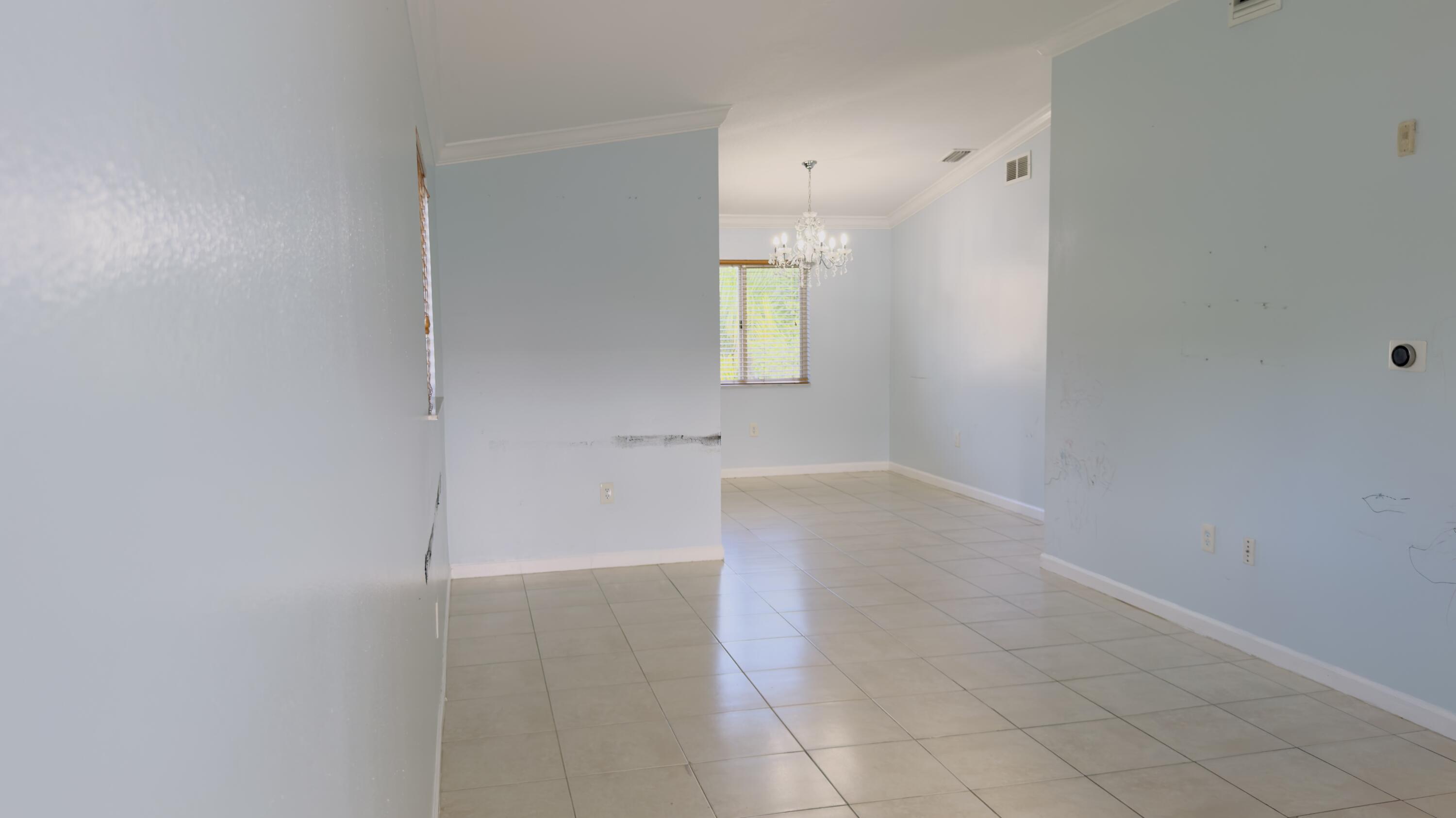 3481 Briar Bay Boulevard, Unit 201 West Palm Beach, FL 33411 - Photo 10 of 19 a view of a kitchen cabinets and a window