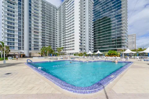a view of a swimming pool with a lounge chair