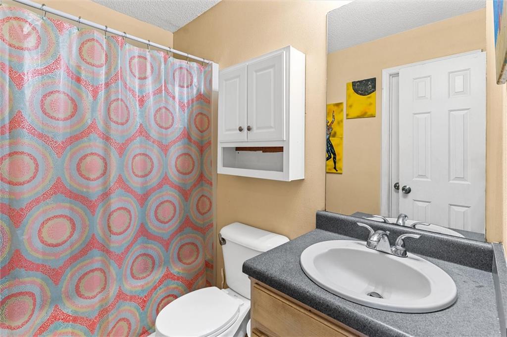 3234 Mineral Ridge Lane Stone Mountain, GA 30087 - Photo 23 of 55 a bathroom with a sink and mirror with toilet