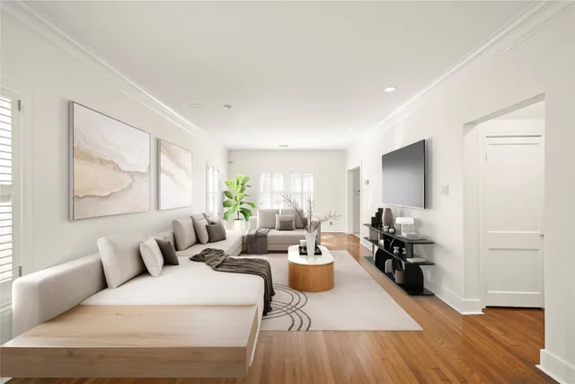 a living room with furniture a large window and wooden floor