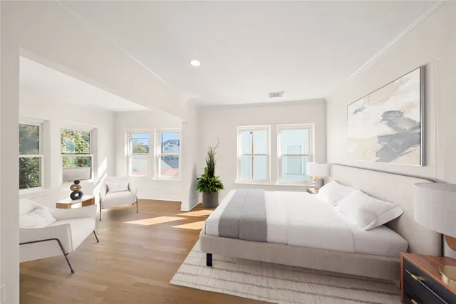 a spacious bedroom with a large bed and a large window