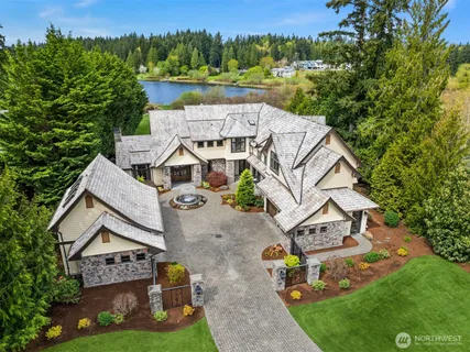 an aerial view of a house with garden space and street view