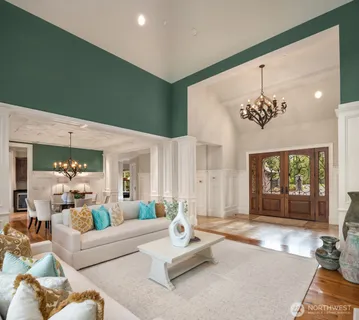 a living room with furniture flowers and a chandelier