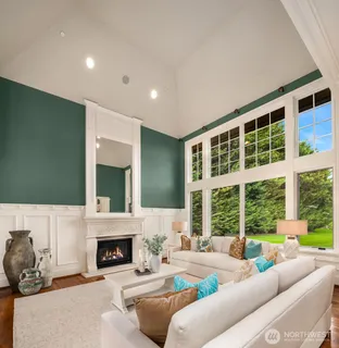 a living room with furniture a fireplace and a large window