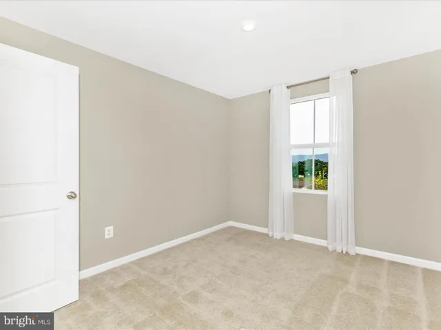 an empty room with closet and a bathroom