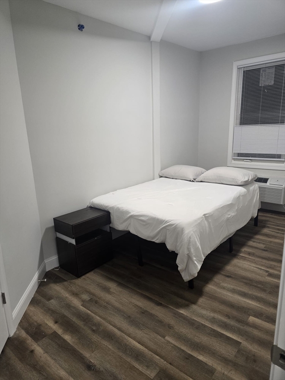 304 Warren Street, Unit 3L Boston, MA 02119 - Photo 7 of 9 a bedroom with a bed and window