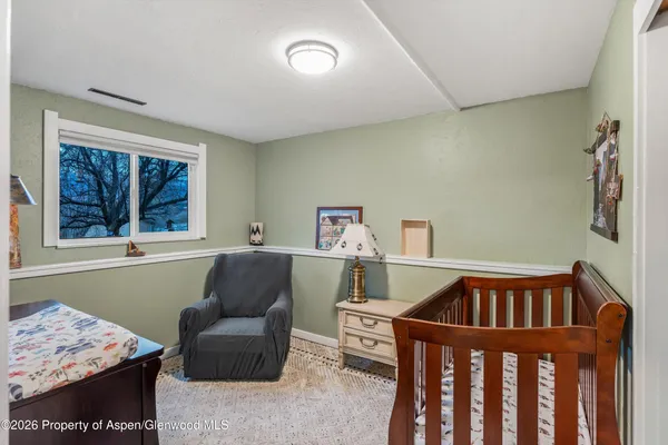 a bedroom with furniture and a window
