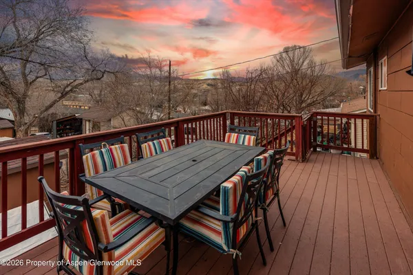a view of a wooden deck with furniture
