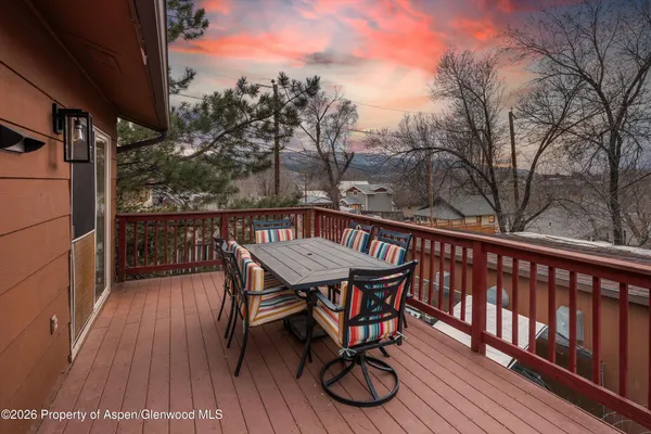a view of balcony with wooden floor and outdoor seating